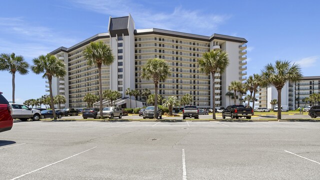 view of apartment building / complex with uncovered parking
