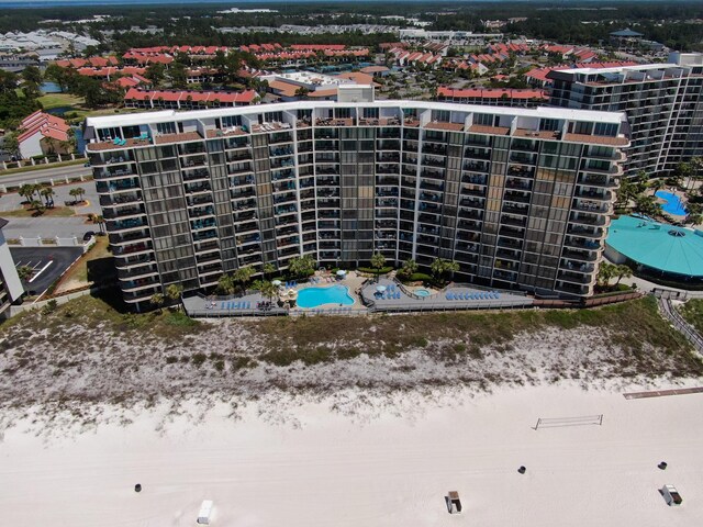 drone / aerial view of a pool and apartment complex