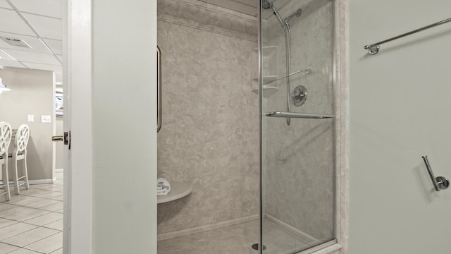 full bath with a shower stall, tile patterned floors, and baseboards