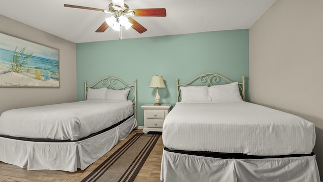 bedroom with ceiling fan and wood finished floors