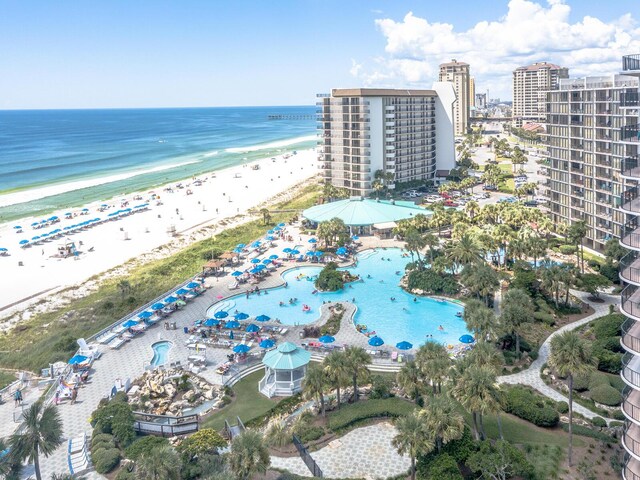 aerial overview of property's location with expansive coastline and a pool area