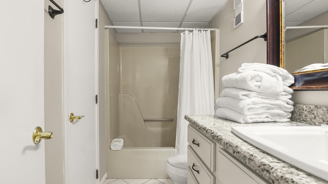 full bath with a paneled ceiling, vanity, tile patterned flooring, toilet, and shower / bath combo with shower curtain