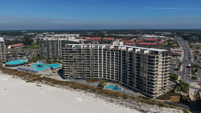 view of urban area featuring a pool and apartment complex / building