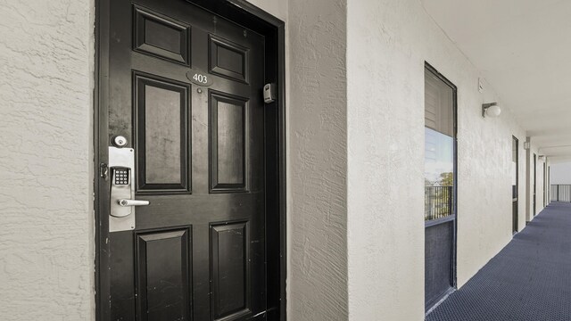 entrance to property with stucco siding