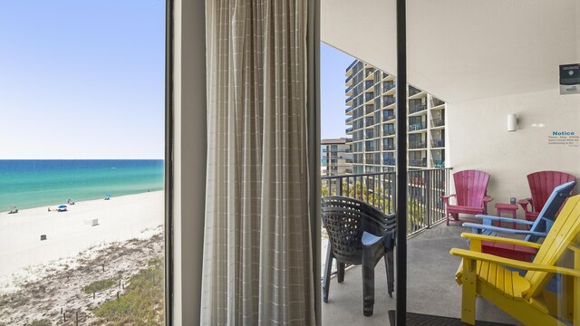 balcony featuring view of water and beach