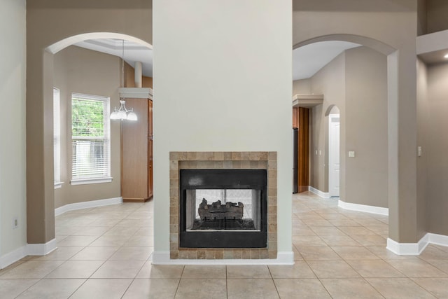 1049 Napa Way, Niceville, FL 32578 - detailed view of a multi sided fireplace, baseboards, and arched walkways