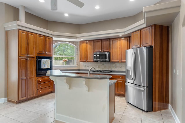 1049 Napa Way, Niceville, FL 32578 - kitchen with appliances with stainless steel finishes, brown cabinetry, light tile patterned floors, and recessed lighting