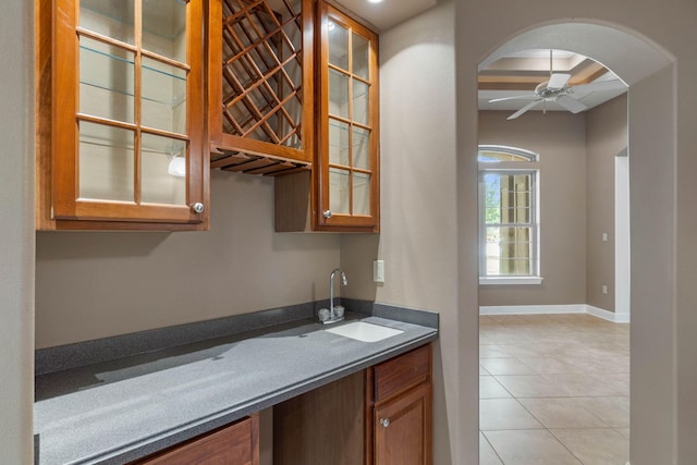 1049 Napa Way, Niceville, FL 32578 - bar featuring a sink, arched walkways, light tile patterned flooring, ceiling fan, and baseboards