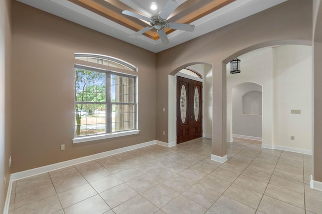 1049 Napa Way, Niceville, FL 32578 - foyer with a tray ceiling, ceiling fan, arched walkways, light tile patterned flooring, and baseboards