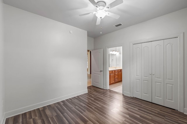 1049 Napa Way, Niceville, FL 32578 - unfurnished bedroom with dark wood-type flooring, baseboards, a closet, connected bathroom, and ceiling fan