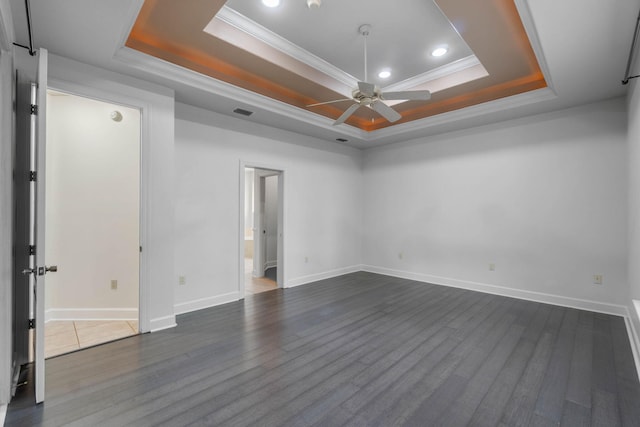 1049 Napa Way, Niceville, FL 32578 - unfurnished room featuring a tray ceiling, a ceiling fan, ornamental molding, dark wood-type flooring, and baseboards