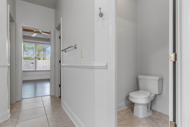 1049 Napa Way, Niceville, FL 32578 - bathroom featuring toilet, a ceiling fan, tile patterned floors, and baseboards