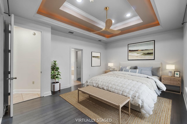 1049 Napa Way, Niceville, FL 32578 - bedroom with a tray ceiling, crown molding, dark wood-style floors, baseboards, and recessed lighting