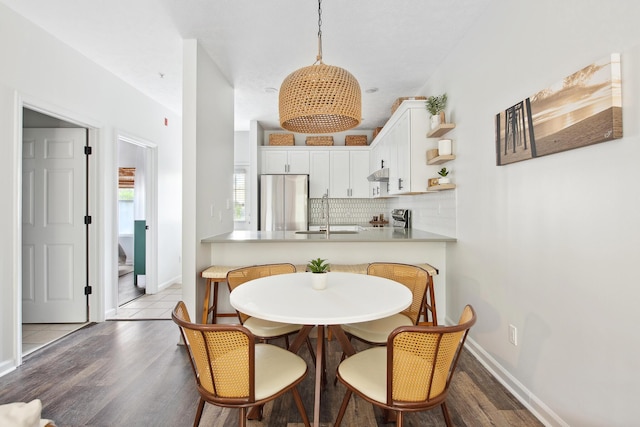 34 Herons Watch Way Unit 1102, Santa Rosa Beach, FL 32459 - dining room featuring wood finished floors, baseboards, and stairs