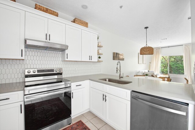 34 Herons Watch Way Unit 1102, Santa Rosa Beach, FL 32459 - kitchen with stainless steel appliances, under cabinet range hood, a sink, light tile patterned floors, and white cabinets
