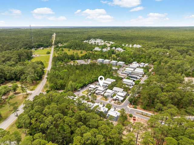 aerial view of property's location featuring a heavily wooded area