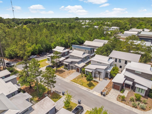 aerial perspective of suburban area featuring a heavily wooded area