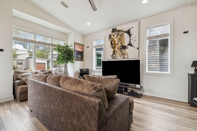 living room with plenty of natural light, light wood-style floors, baseboards, lofted ceiling, and recessed lighting