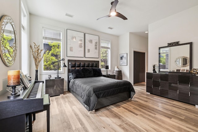 bedroom with light wood-style flooring and a ceiling fan