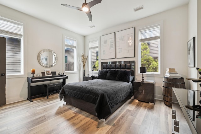 bedroom featuring light wood-style flooring, baseboards, and a ceiling fan