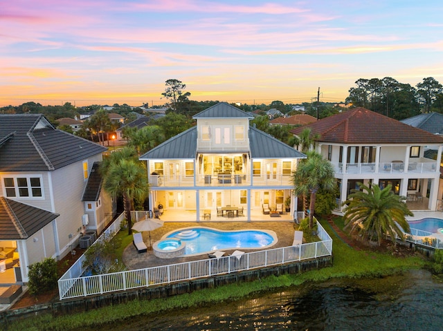 4724 Rendezvous Cv, Destin, FL 32541 - rear view of property with a balcony, a fenced backyard, central AC unit, a pool with connected hot tub, and a patio area