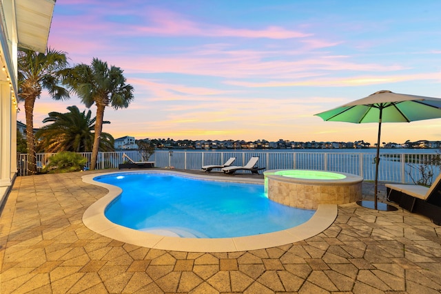 4724 Rendezvous Cv, Destin, FL 32541 - pool at dusk featuring a patio area, a pool with connected hot tub, and fence