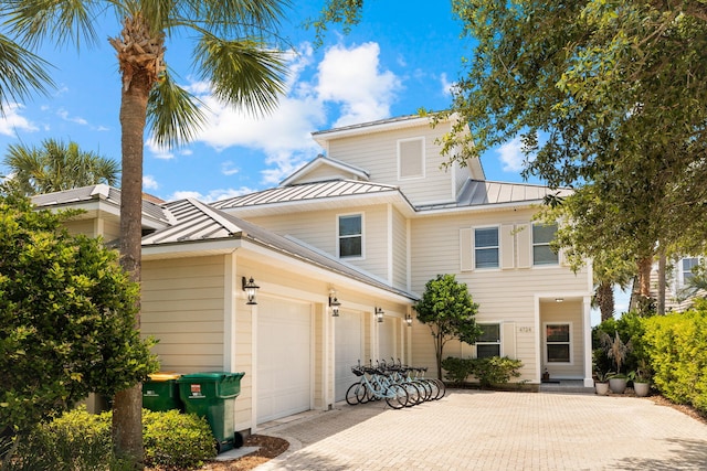 4724 Rendezvous Cv, Destin, FL 32541 - view of front of house with a standing seam roof, a garage, metal roof, and driveway