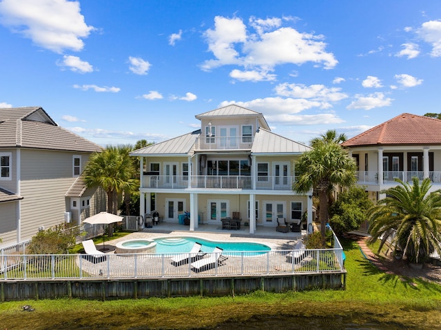 4724 Rendezvous Cv, Destin, FL 32541 - back of house featuring french doors, a balcony, a patio area, a fenced backyard, and a standing seam roof