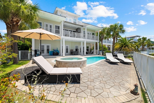 4724 Rendezvous Cv, Destin, FL 32541 - back of property with french doors, fence, an in-ground hot tub, a patio, and a balcony