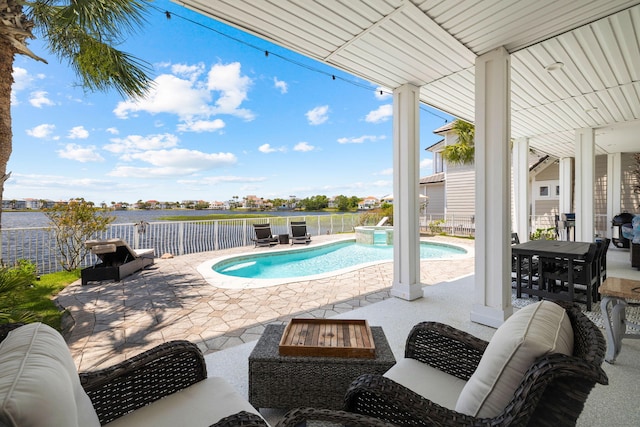 4724 Rendezvous Cv, Destin, FL 32541 - view of pool with a patio area, a pool with connected hot tub, a water view, and a fenced backyard