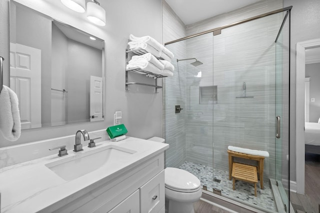 4724 Rendezvous Cv, Destin, FL 32541 - full bathroom with wood finished floors, a shower stall, vanity, and toilet