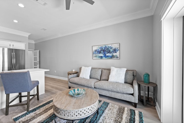 4724 Rendezvous Cv, Destin, FL 32541 - living room featuring crown molding, baseboards, light wood-style floors, recessed lighting, and a ceiling fan
