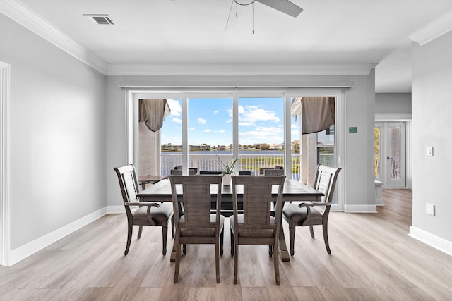 4724 Rendezvous Cv, Destin, FL 32541 - dining room with light wood-type flooring, crown molding, baseboards, a water view, and a ceiling fan