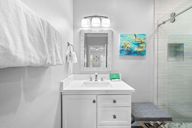 4724 Rendezvous Cv, Destin, FL 32541 - full bath featuring a textured wall, a stall shower, and vanity