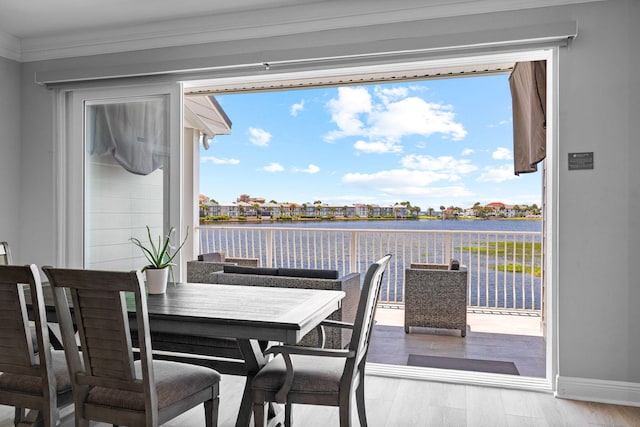 4724 Rendezvous Cv, Destin, FL 32541 - dining room with a water view, ornamental molding, baseboards, wood finished floors, and plenty of natural light