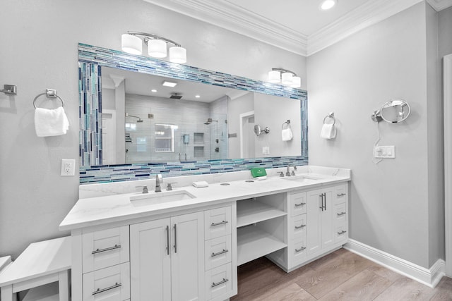 4724 Rendezvous Cv, Destin, FL 32541 - full bathroom with a shower stall, double vanity, ornamental molding, wood finished floors, and baseboards