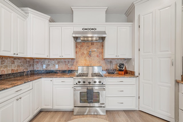 4724 Rendezvous Cv, Destin, FL 32541 - kitchen featuring stainless steel stove, ventilation hood, white cabinetry, and decorative backsplash