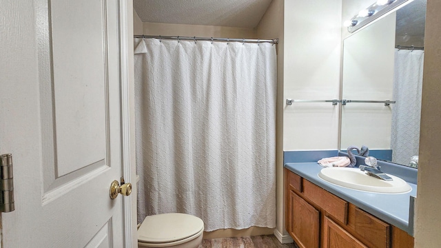 1100 Crosswinds Lndg Unit 21, Fort Walton Beach, FL 32547 - bathroom featuring vanity, toilet, wood finished floors, a shower with shower curtain, and a textured ceiling