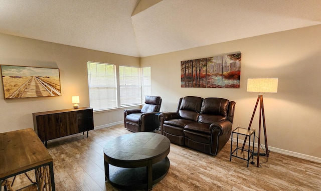 1100 Crosswinds Lndg Unit 21, Fort Walton Beach, FL 32547 - living room featuring wood finished floors, baseboards, vaulted ceiling, and a textured ceiling