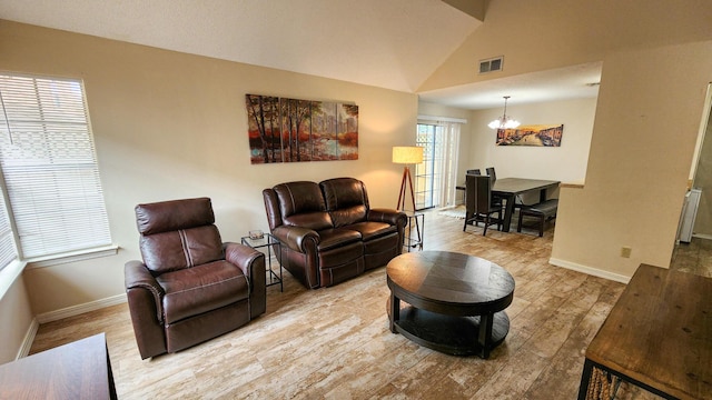 1100 Crosswinds Lndg Unit 21, Fort Walton Beach, FL 32547 - living room with a chandelier, wood finished floors, baseboards, and vaulted ceiling