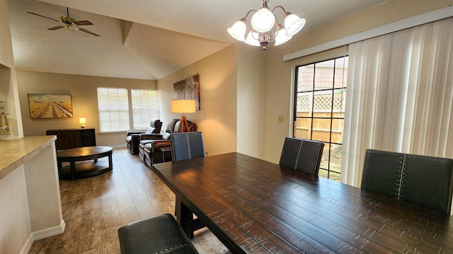 1100 Crosswinds Lndg Unit 21, Fort Walton Beach, FL 32547 - dining area with a chandelier, ceiling fan, baseboards, wood finished floors, and vaulted ceiling