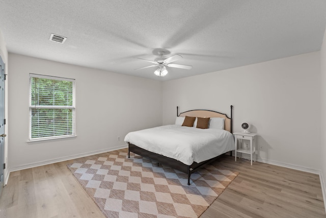 9 5th Ave, Shalimar, FL 32579 - bedroom featuring light wood-style floors, a textured ceiling, baseboards, and a ceiling fan