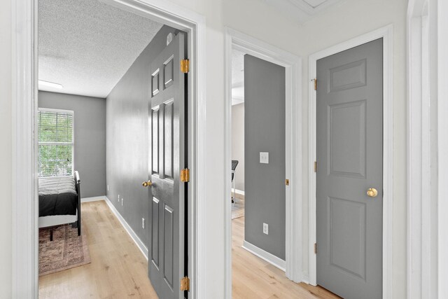 9 5th Ave, Shalimar, FL 32579 - hallway featuring light wood-type flooring, baseboards, and a textured ceiling