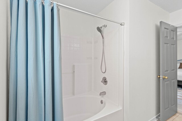 9 5th Ave, Shalimar, FL 32579 - bathroom featuring shower / bath combo, tile patterned flooring, and baseboards