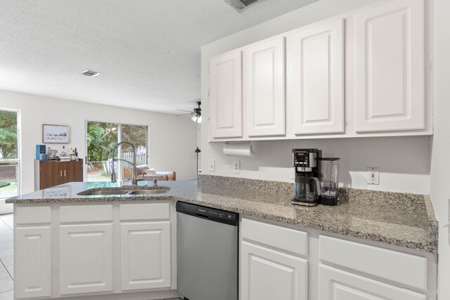 9 5th Ave, Shalimar, FL 32579 - kitchen with dishwasher, a sink, white cabinets, a peninsula, and light stone countertops