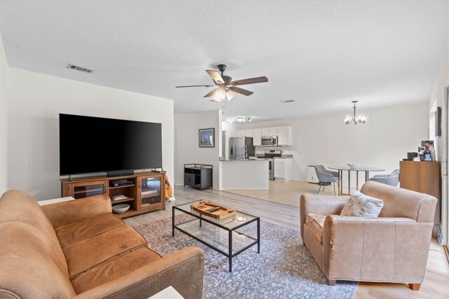 9 5th Ave, Shalimar, FL 32579 - living area with a chandelier, ceiling fan, light wood-style flooring, and baseboards
