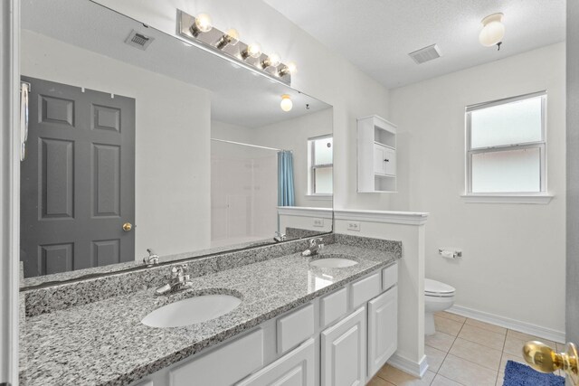 9 5th Ave, Shalimar, FL 32579 - full bathroom with toilet, double vanity, a shower with curtain, tile patterned floors, and baseboards
