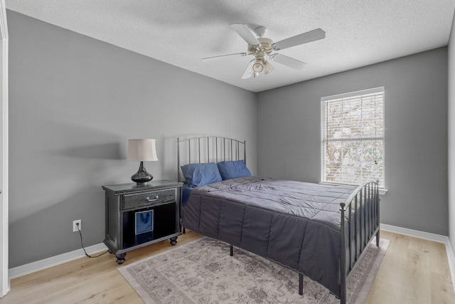 9 5th Ave, Shalimar, FL 32579 - bedroom featuring wood finished floors, baseboards, a textured ceiling, and ceiling fan