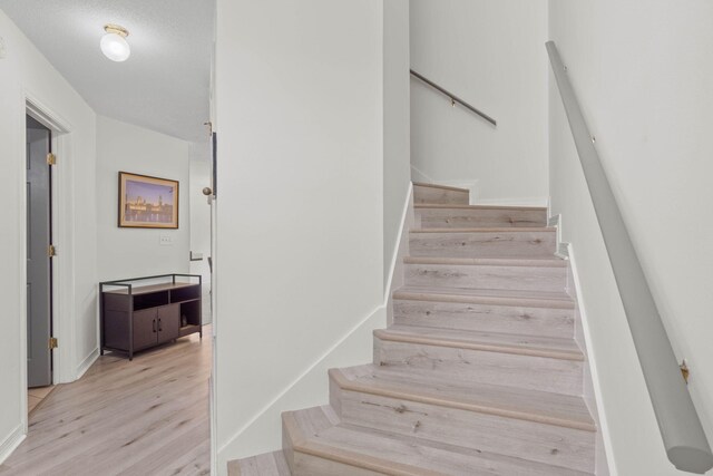 9 5th Ave, Shalimar, FL 32579 - stairway with wood finished floors and baseboards