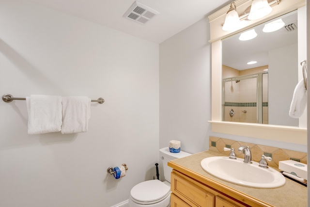 full bath featuring a shower stall, toilet, and vanity